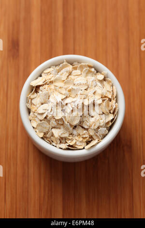 Rolled oats (oat flakes) in a bowl. Close-up. Stock Photo