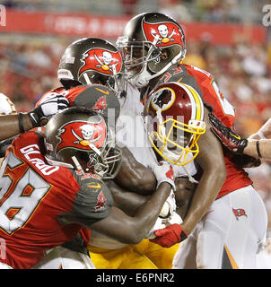 Tampa, Florida, USA. 28th August, 2014. Silas Redd (24) drags the Bucs defense with him on a 1-yard touchdown run during the fourth quarter of the Tampa Bay Buccaneers vs. Washington Redskins preseason game at Raymond James on Thursday (8/28/14) (Credit Image: Credit:  Brendan Fitterer/Tampa Bay Times/ZUMA Wire/Alamy Live News) Stock Photo