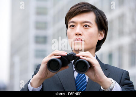 Portrait of a businessman holding binoculars Stock Photo