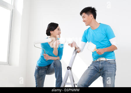 Happy couple taking a break from painting Stock Photo