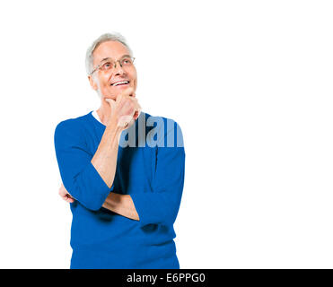 Senior Adult Man Standing With His Hand On His Chin Smiling And Contemplating Stock Photo
