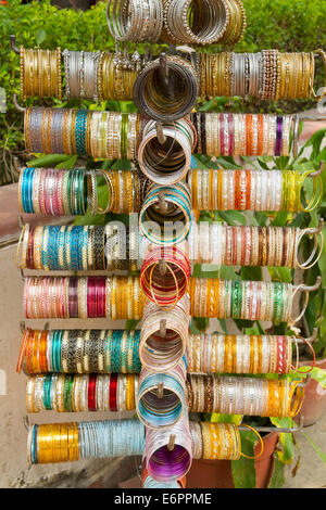 Colorful Indian bangles and bracelets on a stand at Dilli Haat craft market in Delhi, India Stock Photo