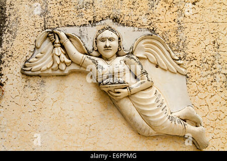 Carved angel detail on an outside wall at Udaipur City Palace in Udaipur, Rajastan, India Stock Photo