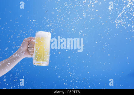 Man holding draft beer and water splash Stock Photo