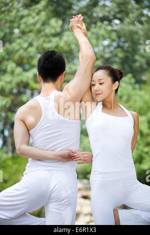 Young couple practicing yoga Stock Photo