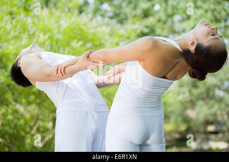 Young couple practicing yoga Stock Photo