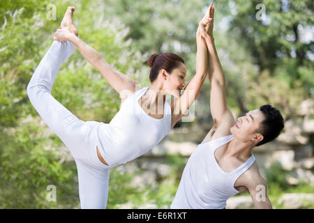 Young couple practicing yoga Stock Photo