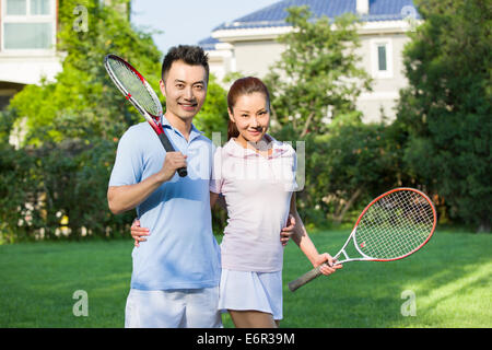 Portrait of young couple with tennis rackets Stock Photo