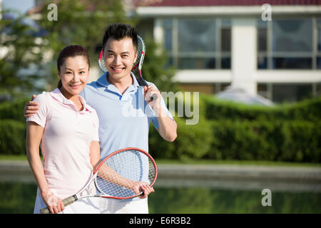 Portrait of young couple with tennis rackets Stock Photo