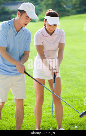 Young couple playing golf Stock Photo