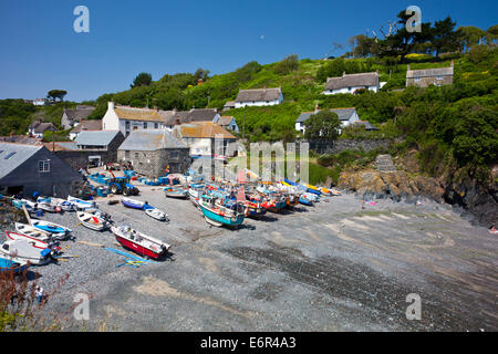 Colourful fishing boats hauled up on the beach at Cadgwith Cove on the Lizard Peninsula Cornwall England UK Stock Photo