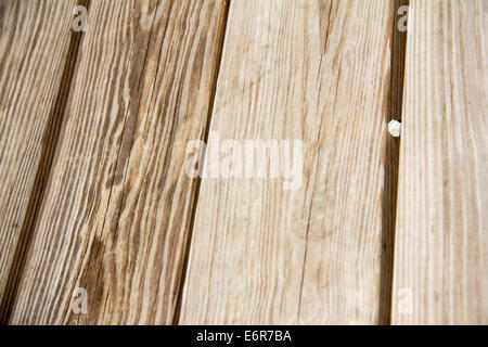 Wood Grain Background with Pebble Wedged in Between Stock Photo