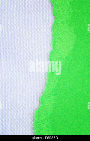 Canvas texture background with delicate stripes pattern and green torn paper Stock Photo