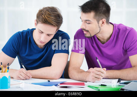 Students taking notes in classroom Stock Photo