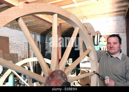 Traditional wheelwright Greg Rowlands working on a new wheel in his workshop at Colyton Devon Stock Photo