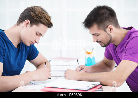 Students taking notes in classroom Stock Photo