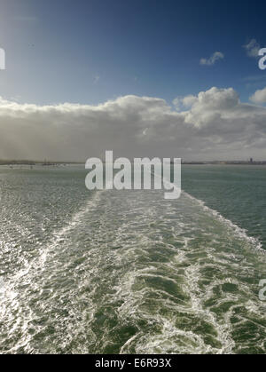 The wake of a cruise ship in the English Channel, taken from above, with blue sky. Stock Photo