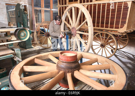 Traditional wheelwright Greg Rowlands working on a new wheel in his workshop at Colyton Devon Stock Photo