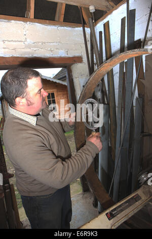 Traditional wheelwright Greg Rowlands working on a new wheel in his workshop at Colyton Devon,using a Wheelwright.Travelers, Stock Photo