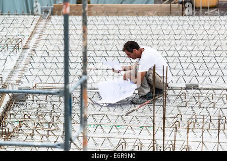 Eengineer checking a blueprint on construction site Stock Photo