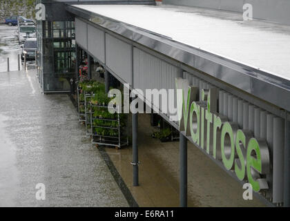 A view looking down into a shopping precinct with the exterior of Waitrose main entrance, and the Waitrose logo, visible - on a Stock Photo