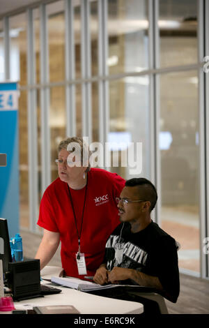 Female teacher tutors a male student inside the computer and tutoring ...