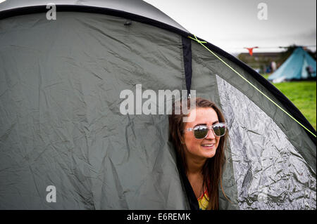 Stow Maries, UK. 29th August 2014. A young female festivalgoer peeps out of her tent at the Brownstock festival. The Brownstock Festival celebrates it's 10th anniversary. Credit:  Gordon Scammell/Alamy Live News Stock Photo