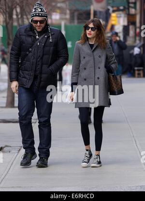 Alexa Chung smoking a cigarette in the East Village as she walks with a friend  Featuring: Alexa Chung Where: New York City, New York, United States When: 24 Feb 2014 Stock Photo