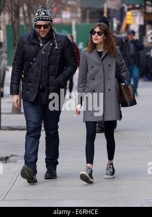 Alexa Chung smoking a cigarette in the East Village as she walks with a friend  Featuring: Alexa Chung Where: New York City, New York, United States When: 24 Feb 2014 Stock Photo