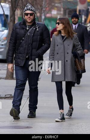 Alexa Chung smoking a cigarette in the East Village as she walks with a friend  Featuring: Alexa Chung Where: New York City, New York, United States When: 24 Feb 2014 Stock Photo