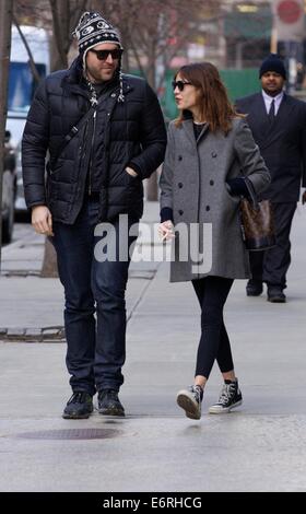 Alexa Chung smoking a cigarette in the East Village as she walks with a friend  Featuring: Alexa Chung Where: New York City, New York, United States When: 24 Feb 2014 Stock Photo