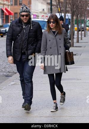 Alexa Chung smoking a cigarette in the East Village as she walks with a friend  Featuring: Alexa Chung Where: New York City, New York, United States When: 24 Feb 2014 Stock Photo