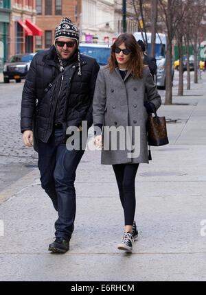 Alexa Chung smoking a cigarette in the East Village as she walks with a friend  Featuring: Alexa Chung Where: New York City, New York, United States When: 24 Feb 2014 Stock Photo