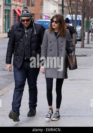 Alexa Chung smoking a cigarette in the East Village as she walks with a friend  Featuring: Alexa Chung Where: New York City, New York, United States When: 24 Feb 2014 Stock Photo