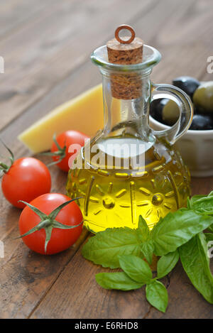 Ingredients of italian cuisine  - cherry tomato, basil, parmesan and olive oil - on wooden background Stock Photo