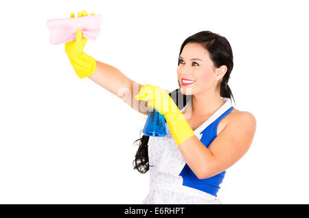 Beautiful young girl wearing apron and gloves cleaning Stock Photo