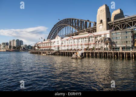 Walsh Bay in Sydney showing Pier One in front of the Harbour Bridge looking North East Stock Photo
