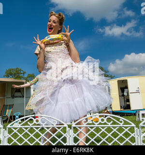 A retro woman dressed in a 50s vintage inspired dress posing with