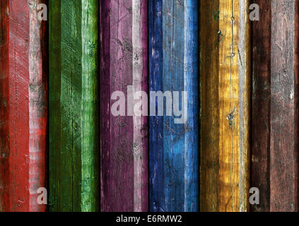 Wall of rough wooden poles painted in several colors Stock Photo