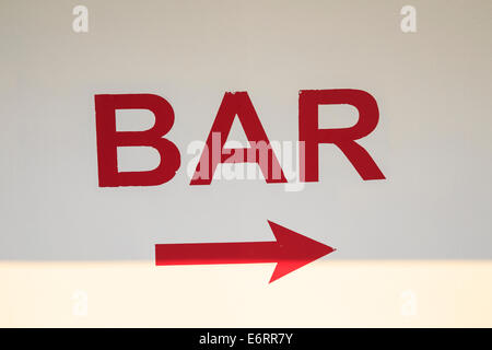 Sign painted on a wall, pointing to the bar Stock Photo