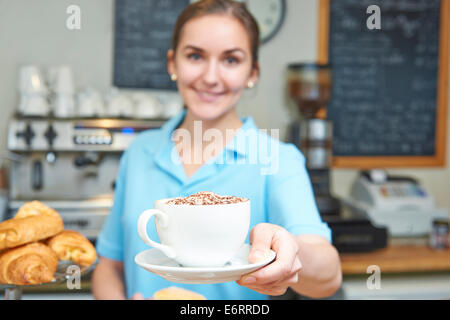 Waitress In Cafe Serving Customer With Coffee Stock Photo