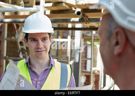 Architect Discussing Plans With Builder Stock Photo