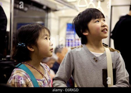 Little boy and girl traveling on subway train, Tokyo, Japan, Asia Stock Photo