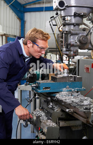 Male Engineer Using Drill In Factory Stock Photo