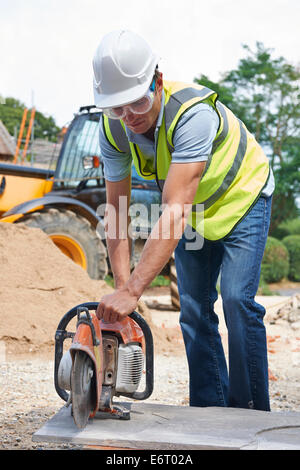 Construction Worker Cutting Stone With Circular Saw Stock Photo