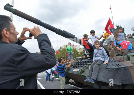 Istanbul, Turkey. 30th Aug, 2014. Children sit on tanks after a military parade marking the 92nd anniversary of the Victory Day in Istanbul, Turkey, Aug. 30, 2014. Turkey commemorated the anniversary of the day in 1922 that marked the end of Turkey's independence war with a victory over Greek occupation troops in Anatolia. Credit:  Lu Zhe/Xinhua/Alamy Live News Stock Photo
