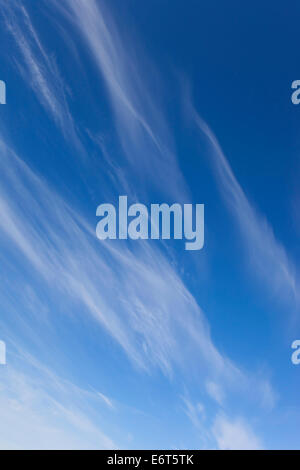 Wispy white cirrus clouds in blue sky background with copy space ...