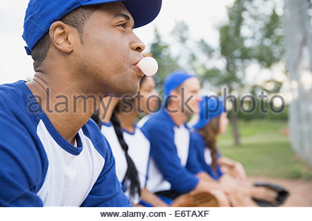 Baseball player blowing bubble gum bubble on field