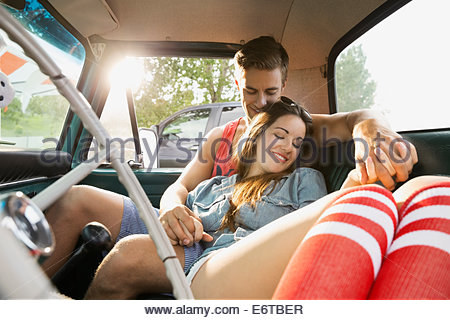 Couple relaxing together in truck