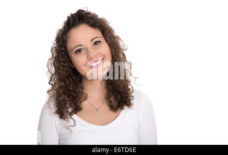 Isolated portrait: smiling brunette young woman or girl in white shirt with curls. Stock Photo